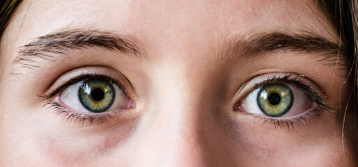 Close-up of beautiful green eyes of a woman