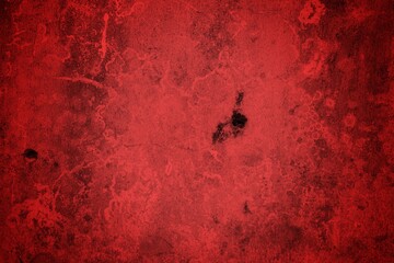 A textured background featuring deep red tones with a distressed, grunge appearance. The surface shows scratches and uneven patterns, creating a vintage feel.