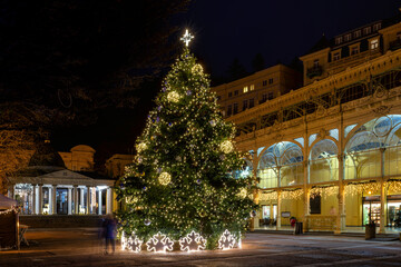Fototapeta na wymiar Decorated main colonnade at Advent time with Christmas tree - evening photography of Czech spa town Marianske Lazne (Marienbad) - Czech Republic, Europe
