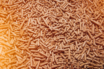 Wooden pellet top view. Close-up of ecological and sustainable fuel. Renewable house heating material. Woodpellet macro.