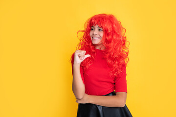 cheerful teen kid with red long hair on yellow background