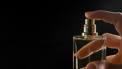Frame macro spraying perfume on a dark background