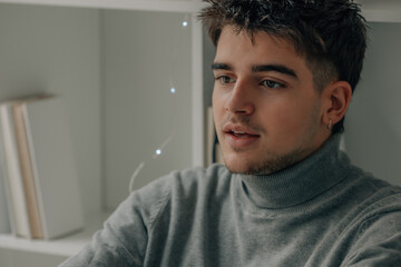 young man at home with mobile phone or smartphone