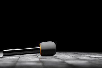 Microphone for an interview or reportage on floor on black background. Announcement, presentation...