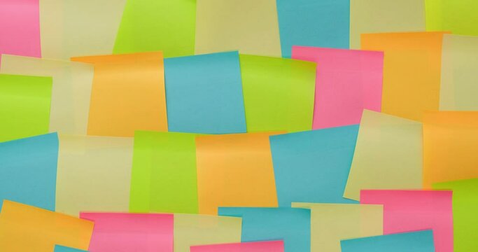 Multicolored memo notes on a black background. 4K stop motion animation