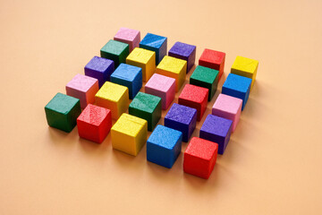 Fototapeta premium A square of multi-colored cubes as a symbol of order and company management.
