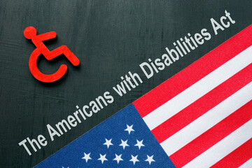 ADA or The Americans with Disabilities Act concept. Disabled person sign and USA flag.