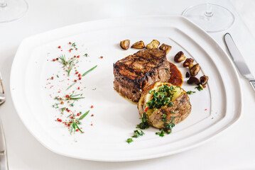 steak with baked potato and sauce