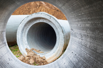 Modern water supply and sewerage system. Underground pipeline works. Water supply and wastewater disposal of a residential city. Close-up of underground utilities. View from the big pipe.