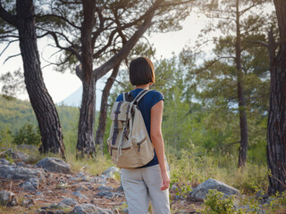 Naklejka na ściany i meble woman traveler walking by Lycian Way trail mountains in Turkey near Antalya. concept of living open-air, physical and mental well-being, digital detox