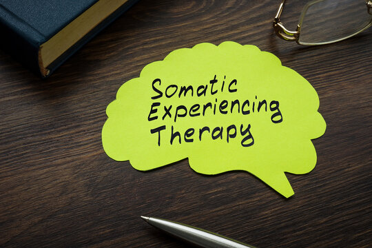Somatic experiencing therapy sign on the page with brain shape.