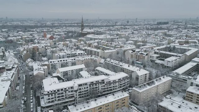 Munich winter snowfall aerial skyline view fly over munich germany giesing district in front munich cathedral.