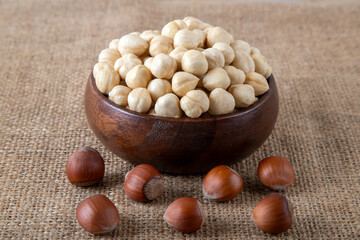 View of a bowl full of hazelnuts on burlap sack