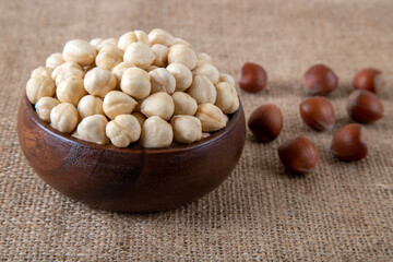 View of a bowl full of hazelnuts on burlap sack
