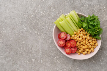 Healthy food plate with various raw vegetables and boiled chickpeas, vegetarian food, top view
