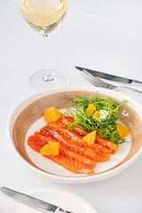 salmon with orange and microgreens