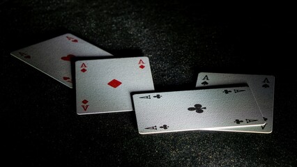 Poker, four Aces, dimly lit shady poker cards thrown on poker table