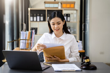 Fototapeta premium Lawyer woman working with paperwork on his desk in office workplace for consultant lawyer in office.