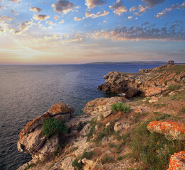 Rocky summer coastline and cape with pavilion