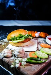 A burger is a flat round mass of minced meat or vegetables, which is fried and often eaten in a bread roll