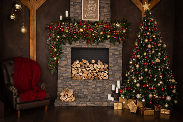Fireplace made of stone, decorated for Christmas. A large Christmas tree and a chair in the studio
