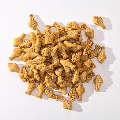 Sweets, cookies in the form of a fish with catnip, food supplement, on a white background, top view