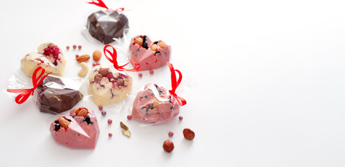 Chocolate candy in the form of hearts, homemade production, gift, on white background, banner, place for text