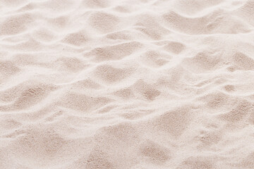 Fototapeta na wymiar Fine Sand texture natural surface. Close up of sand on shore sea, white waves dunes, pink neutral color, minimal nature aesthetics wallpaper. Sandy beach for background, selective focus
