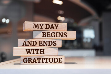 Wooden blocks with words 'My Day Begins and Ends with Gratitude'.