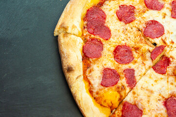 classic traditional dish pepperoni pizza with sausage Italian cuisine on a wooden background