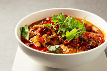 skewered vegetables and meat cooked in a hot and spicy soup