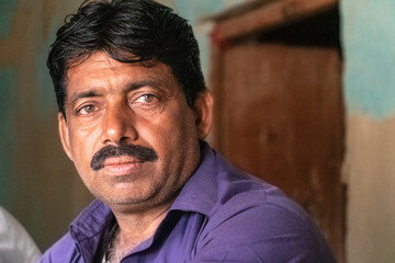 an asian young man with worried expression on his face