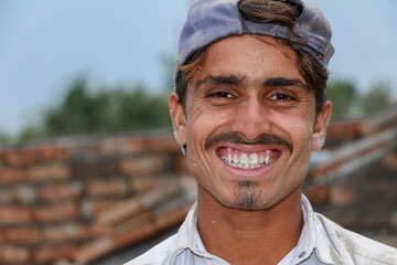 a worker is working at a construction site and smilling