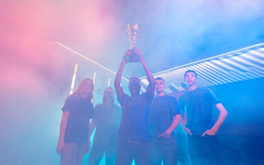 Concept championship cyber gaming esport. Winner team gamer holding cup trophy of victors video...
