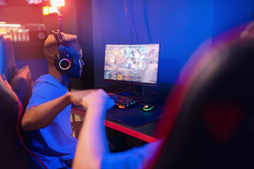 Two man professional cyber sport gamers giving fist hand bump. Concept winner eSports tournament. Neon color soft focus