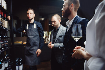 Business meeting of colleagues with discussion of choice of wine and alcohol in restaurant