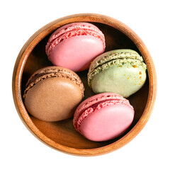 Macarons, French macaroons in a wooden bowl. Sweet meringue-based confection, Parisian-style, made with egg white, sugar, almonds and food coloring, presented with ganache, buttercream or jam filling.