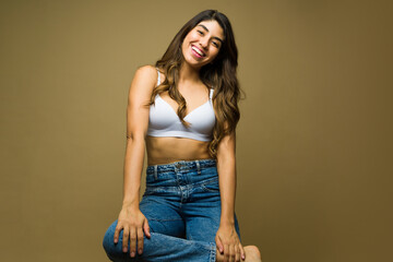 Excited woman laughing wearing a bra and jeans - Powered by Adobe