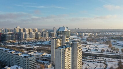 Obraz premium Vostok microdistrict in Minsk in winter. Sleeping areas of the capital of Belarus in the snow. Snow-covered Minsk in winter. Aerial photography of Minsk from above. Eastern Europe.