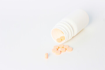 Vitamin D3, Orange Medical Tablets with Bottles on a White Background. Left Copy Space