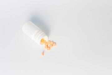 Vitamin D3, Orange Medical Tablets with Bottles on a White Background. Right Copy Space