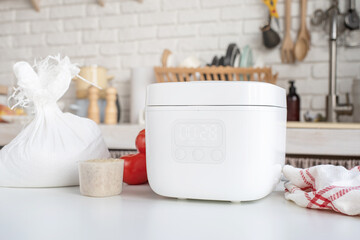 Electric rice cooker on wooden counter-top in the kitchen