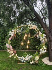round arch for a wedding ceremony with light bulbs