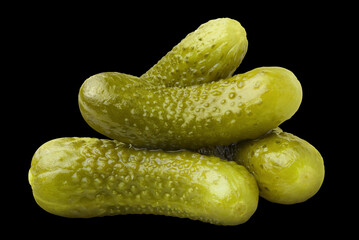 Marinated pickled cucumbers close-up, isolated on black background