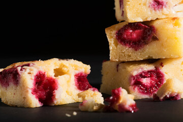 Raspberry vanilla cake on black background