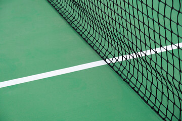 Green tennis court with net