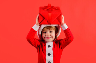 Little Santa Claus gifting gift. Christmas child with present box. Preparing for New Year holidays.
