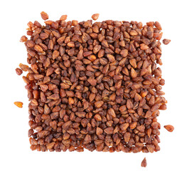 Buckwheat tea isolated on white background. Whole roasted buckwheat grains. Fagopyrum tataricum. Top view.