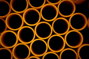Background of the orange plastic pipes in stacked
