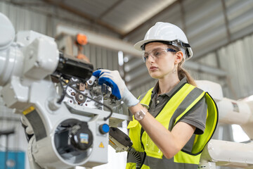 Female automation engineer wear vest with helmet safety using tablet checking and inspection...